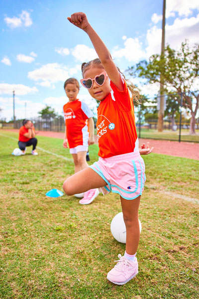 Girl in Soccer Shots jersey cheering